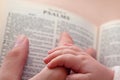 Baby Holding DadÃ¢â¬â¢s Finger on Bible